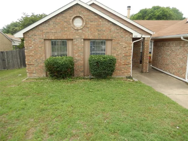 a view of backyard of house with green space