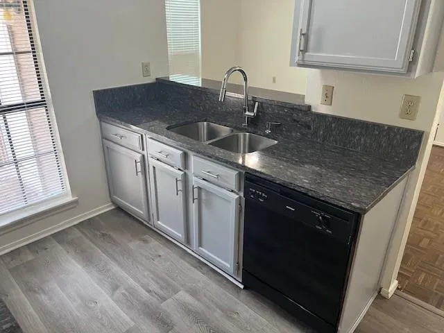 a kitchen with a sink stove and cabinets