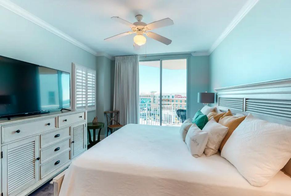 1110 Santa Rosa Boulevard, Unit A621 Fort Walton Beach, FL 32548 - Photo 12 of 20 a bedroom with a bed and a flat screen tv