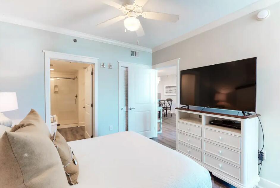1110 Santa Rosa Boulevard, Unit A621 Fort Walton Beach, FL 32548 - Photo 13 of 20 a bedroom with a bed and a flat screen tv in it
