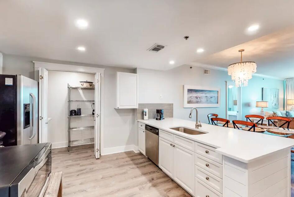 1110 Santa Rosa Boulevard, Unit A621 Fort Walton Beach, FL 32548 - Photo 2 of 20 a large white kitchen with a refrigerator a sink and a stove