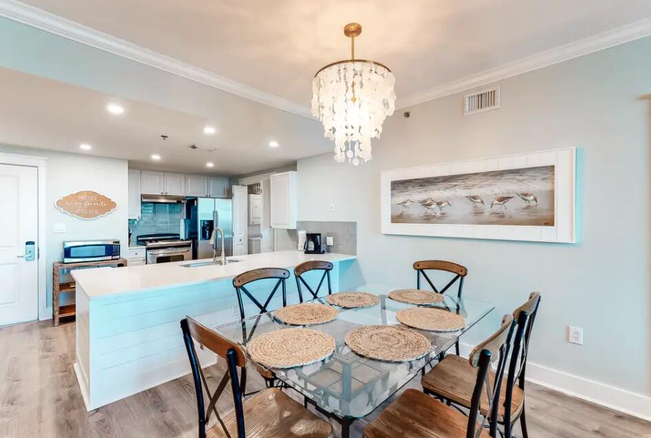 1110 Santa Rosa Boulevard, Unit A621 Fort Walton Beach, FL 32548 - Photo 5 of 20 a view of a dining room with furniture wooden floor and chandelier
