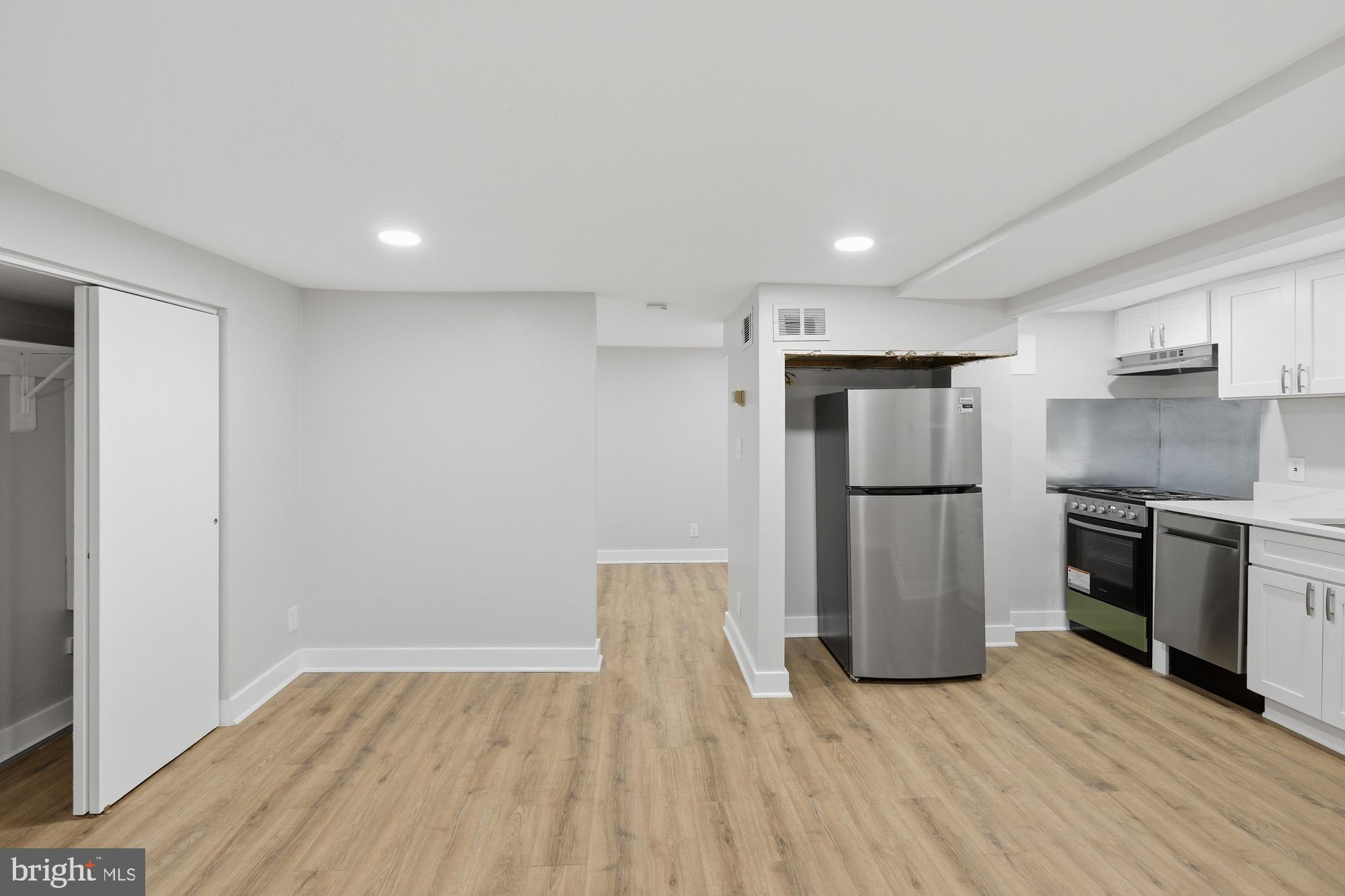2388 Champlain Street Northwest, Unit 2 Washington, DC 20009 - Photo 5 of 13 a kitchen with a refrigerator and a stove top oven