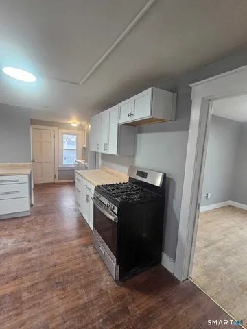 a kitchen with stainless steel appliances granite countertop a stove and a refrigerator