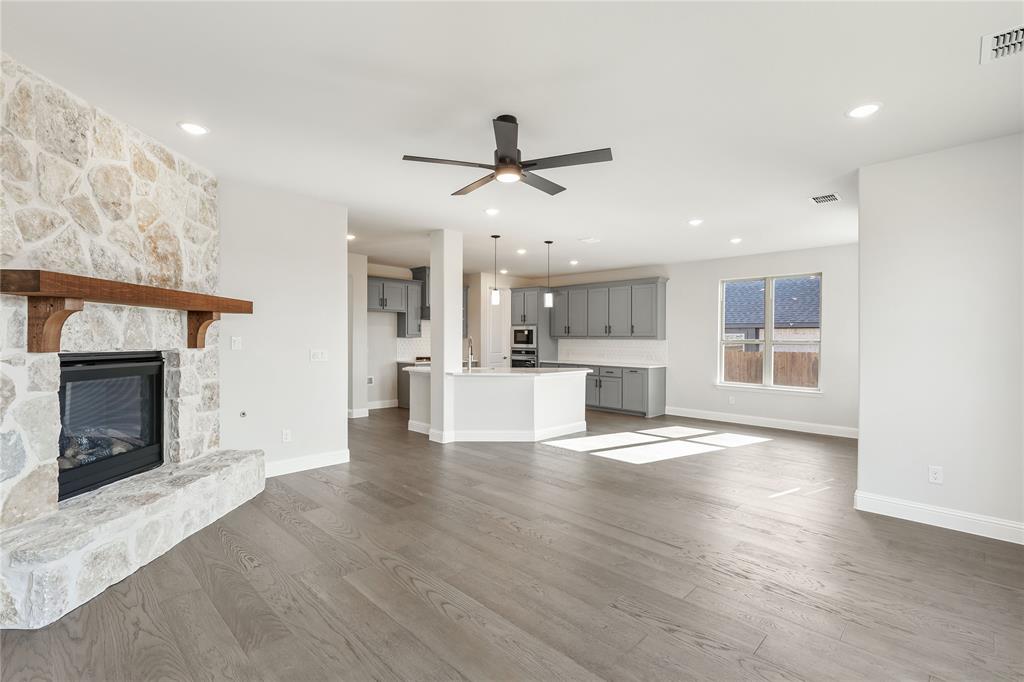 8 Grouse Circle Sanger, TX 76266 - Photo 16 of 40 a view of a kitchen with a sink and a fireplace