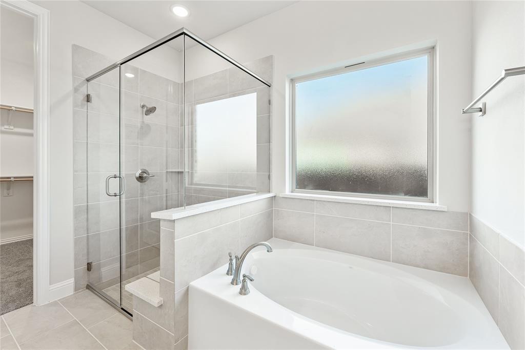 8 Grouse Circle Sanger, TX 76266 - Photo 21 of 40 a bathroom with a bathtub and a shower