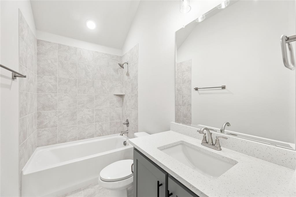 8 Grouse Circle Sanger, TX 76266 - Photo 30 of 40 a bathroom with a granite countertop sink a toilet and shower
