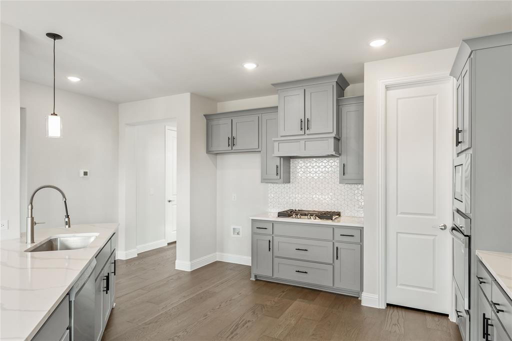 8 Grouse Circle Sanger, TX 76266 - Photo 7 of 40 a kitchen with white cabinets and appliances