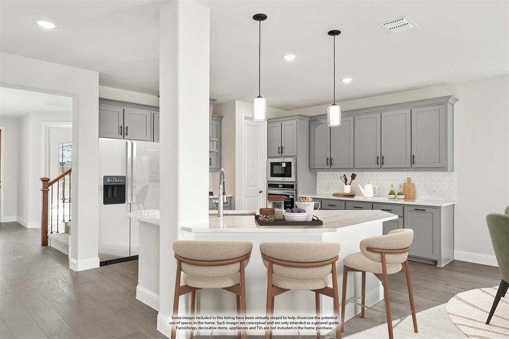 8 Grouse Circle Sanger, TX 76266 - Photo 9 of 40 a kitchen with a dining table chairs sink and cabinets