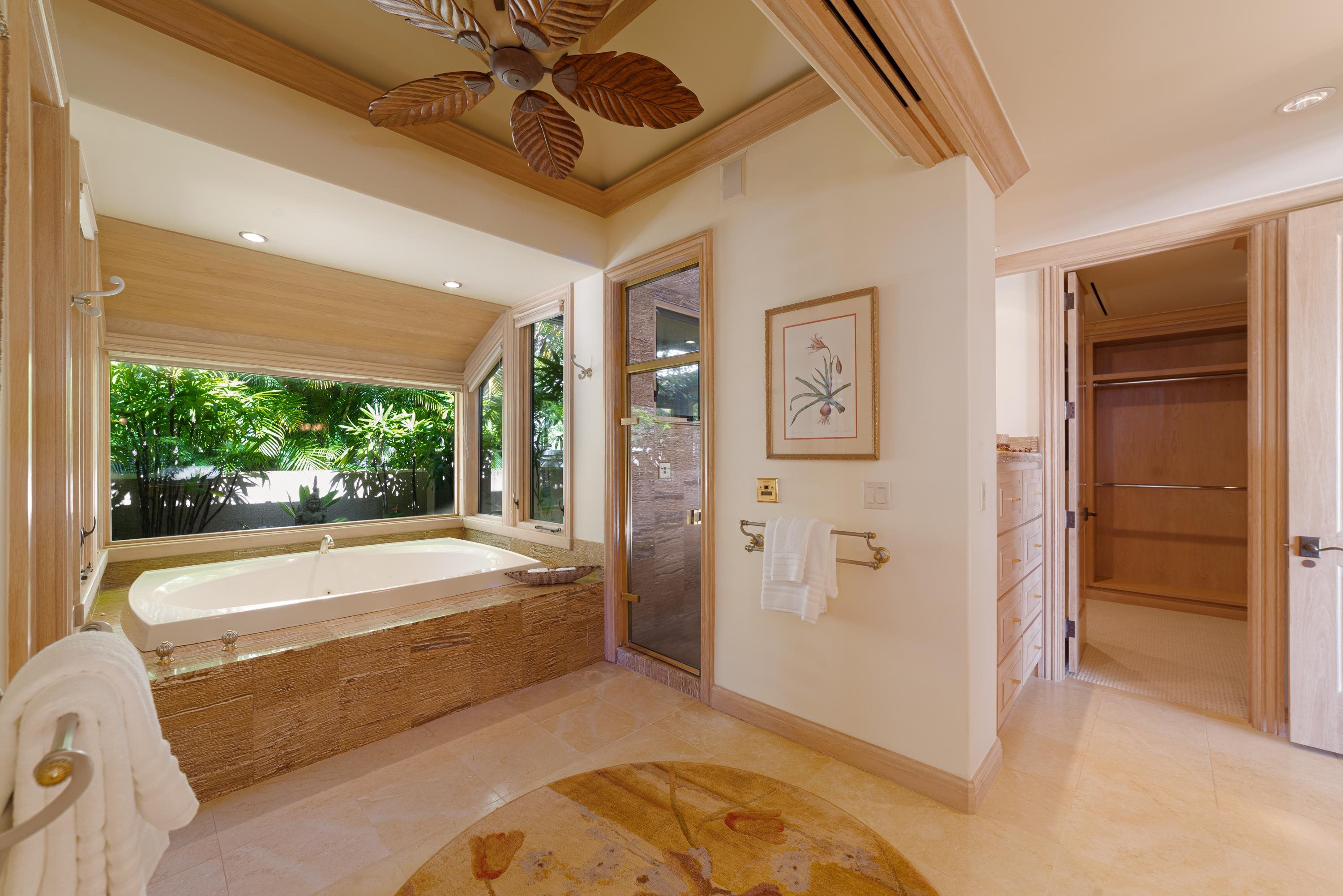 1216 Summer Road Lahaina, HI 96761 - Photo 16 of 26 a spacious bedroom with a large bed and a chandelier