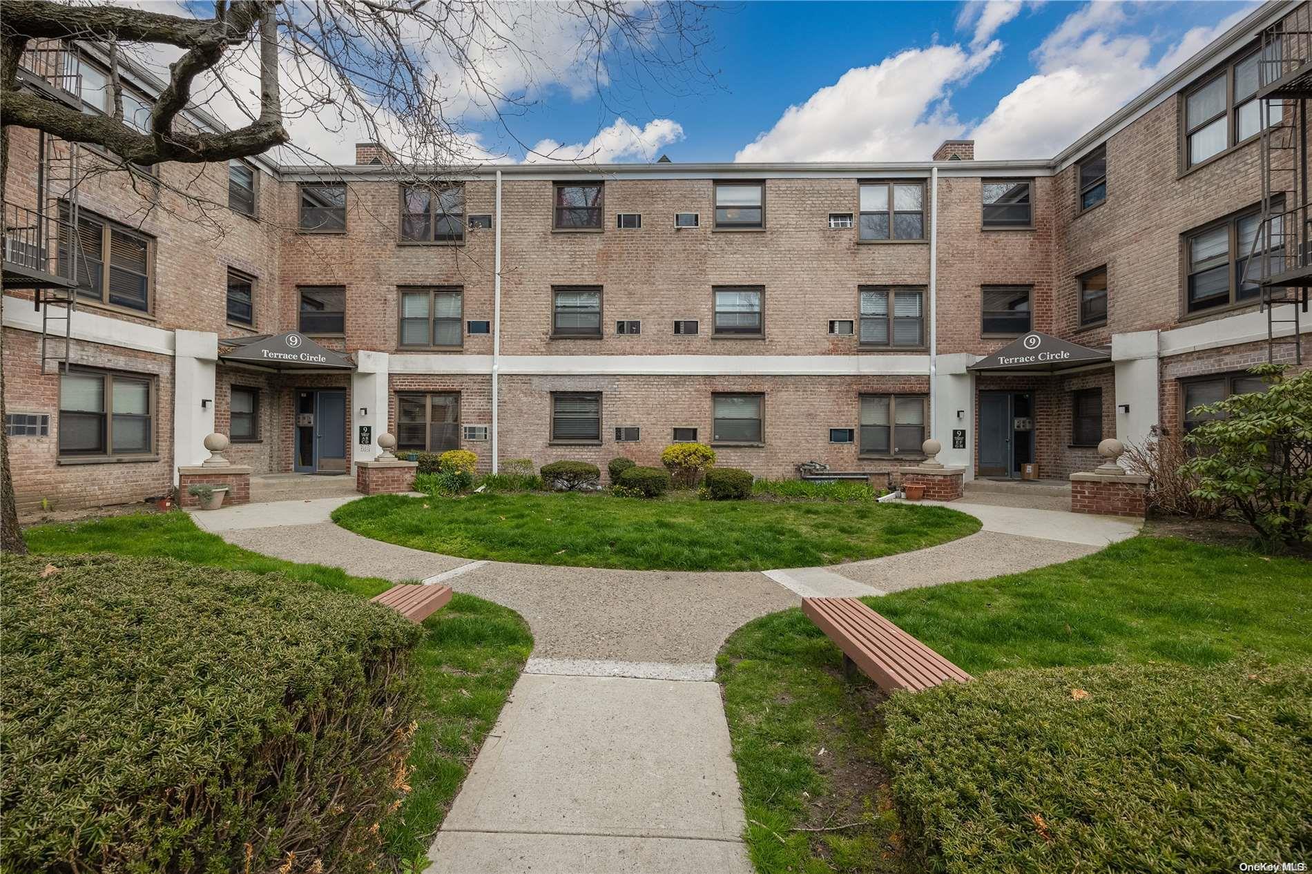 9 Terrace Circle, Unit 2G Great Neck, NY 11021 - Photo 1 of 1 a view of a building with a yard