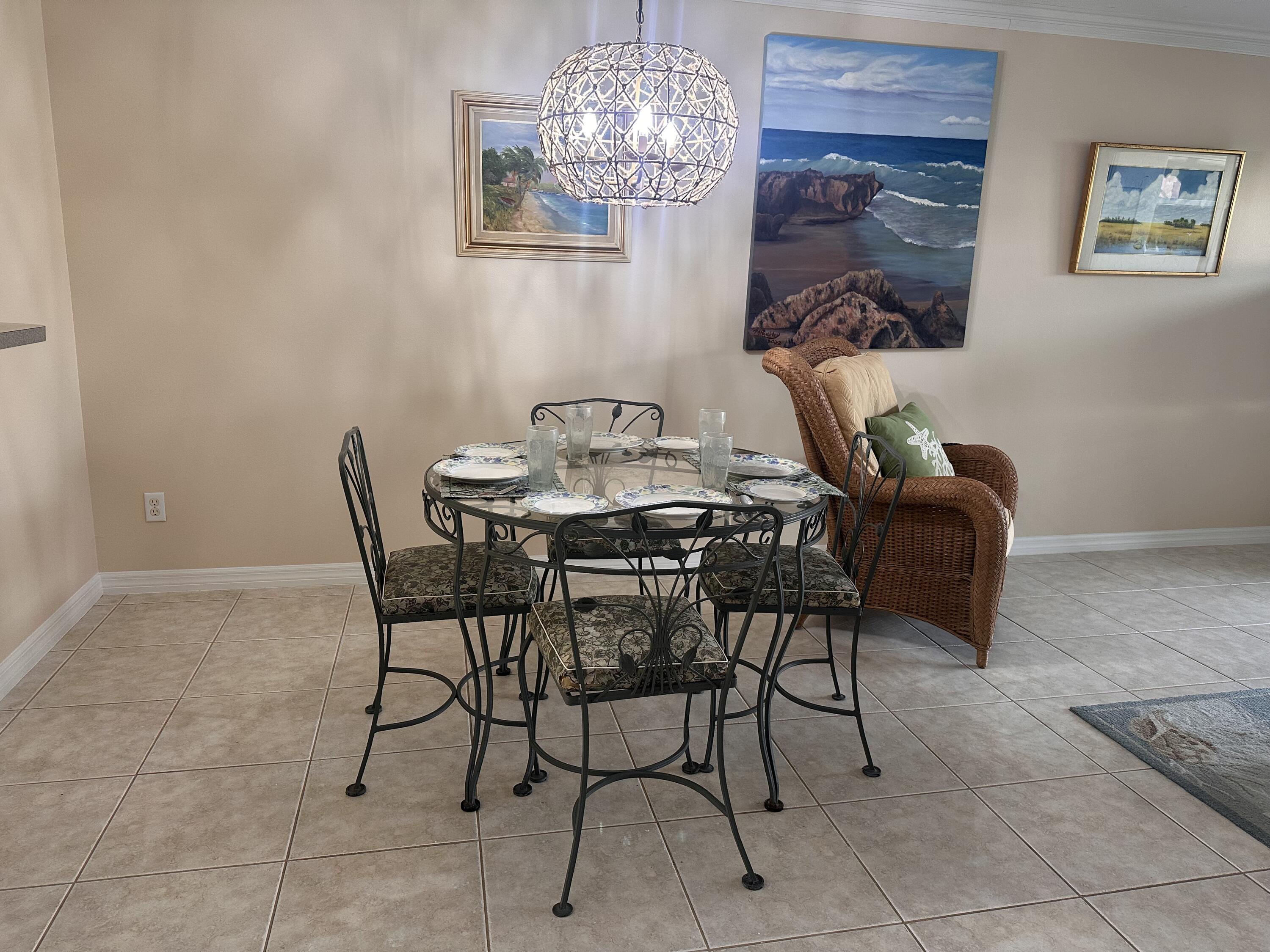 2950 Southeast Ocean Boulevard, Unit 182 Stuart, FL 34996 - Photo 5 of 13 a view of a dining room with furniture and chandelier