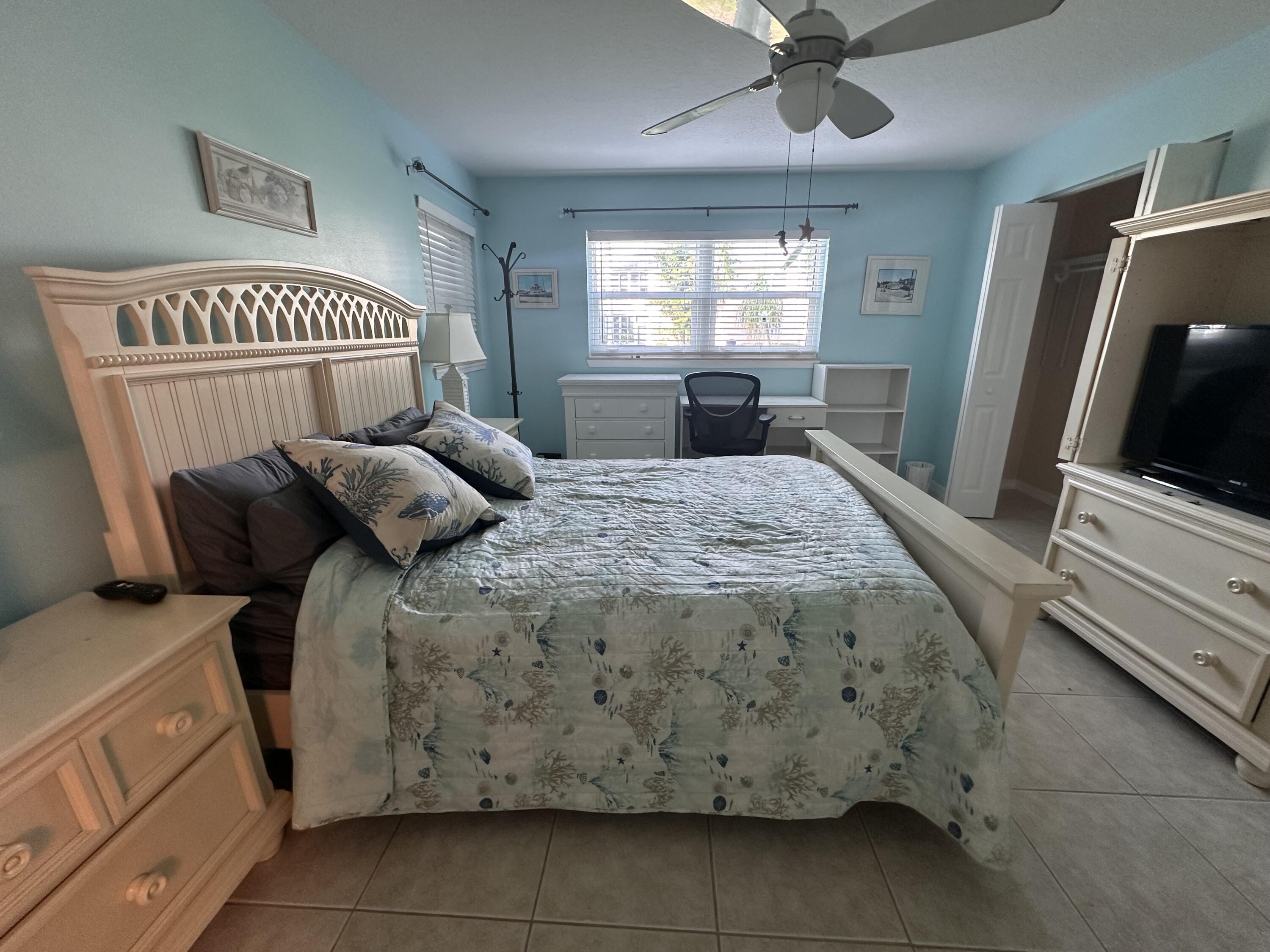 2950 Southeast Ocean Boulevard, Unit 182 Stuart, FL 34996 - Photo 7 of 13 a bedroom with a bed and a flat screen tv