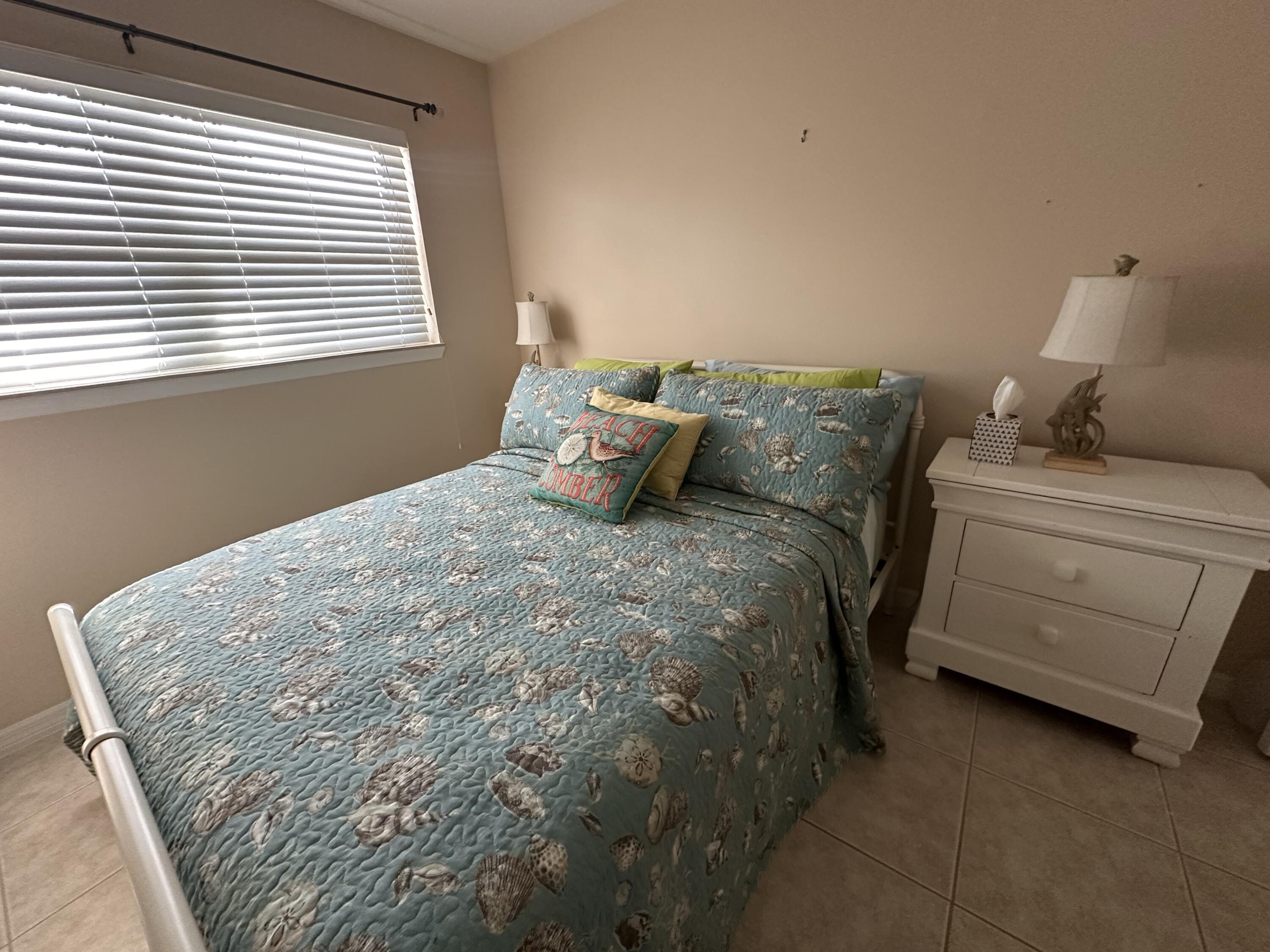 2950 Southeast Ocean Boulevard, Unit 182 Stuart, FL 34996 - Photo 10 of 13 a bedroom with a bed and a window