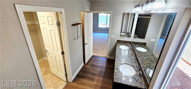 6302 Jackson Spring Road Las Vegas, NV 89118 - Photo 27 of 48 Double vanity with stone counters provides ample space in this well-appointed bathroom.