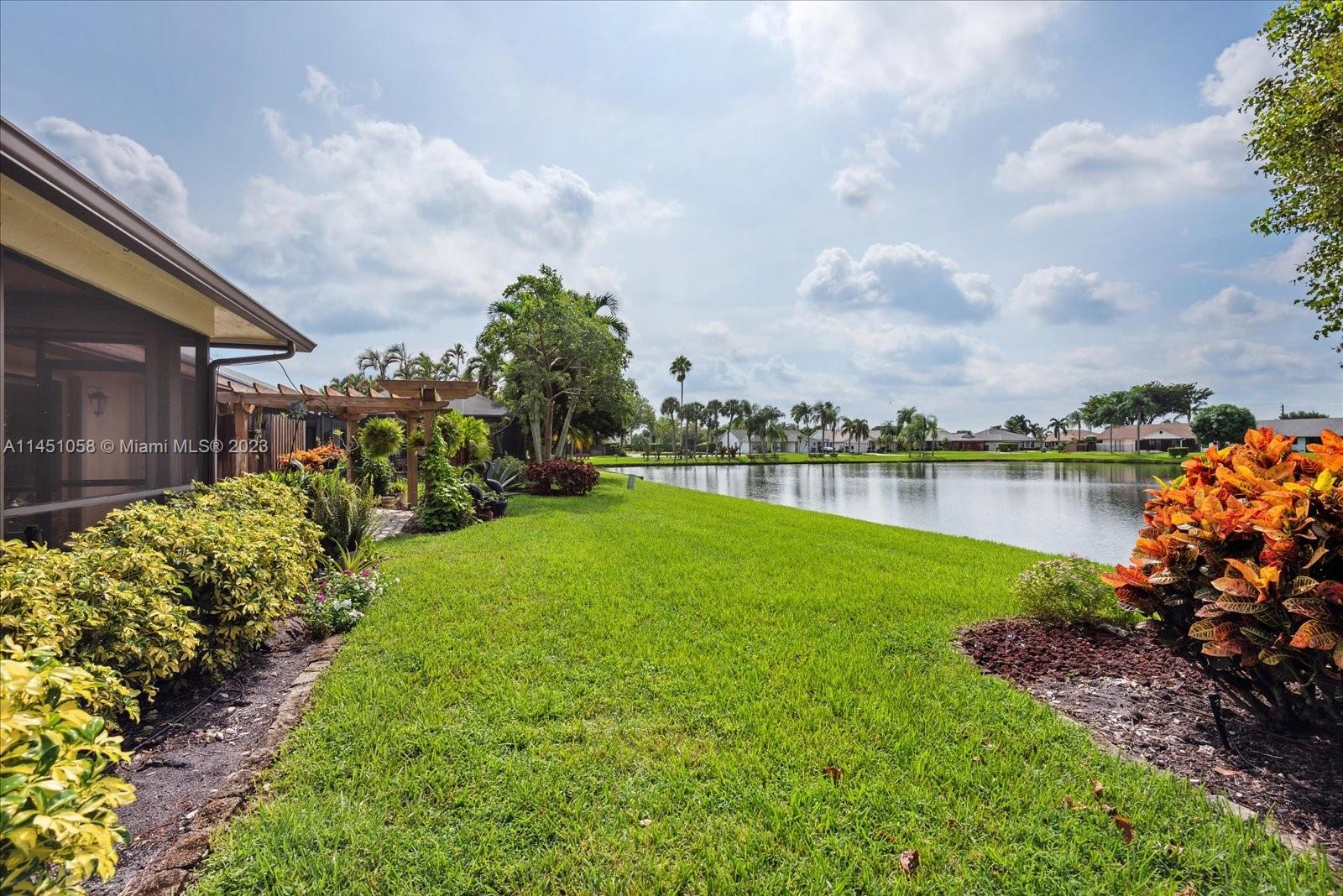 9757 Majorca Place Boca Raton, FL 33434 - Photo 16 of 26 a view of a lake with a house in the background