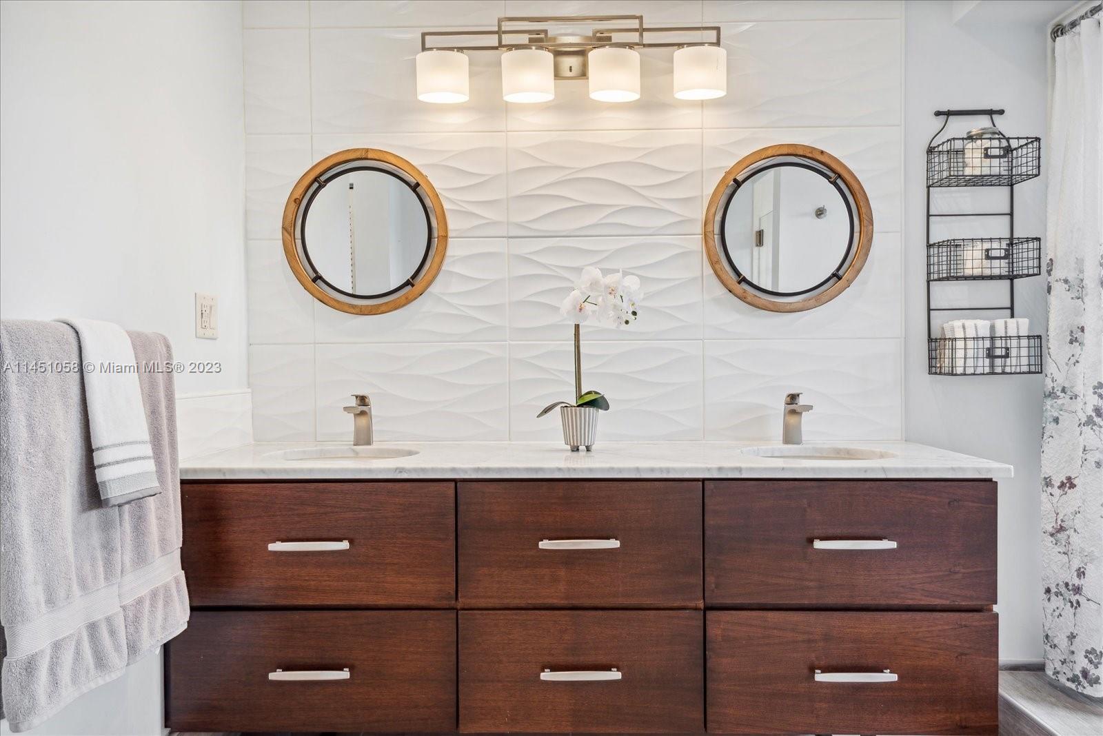 9757 Majorca Place Boca Raton, FL 33434 - Photo 7 of 26 a bathroom with a sink and a mirror