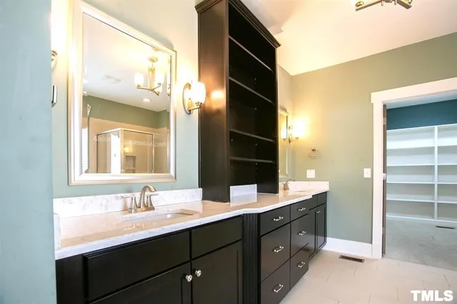 a bathroom with a double vanity sink and mirror
