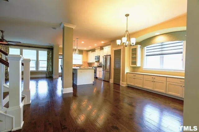 a view of a living room with kitchen view and a window