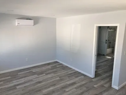 a view of a room with wooden floor