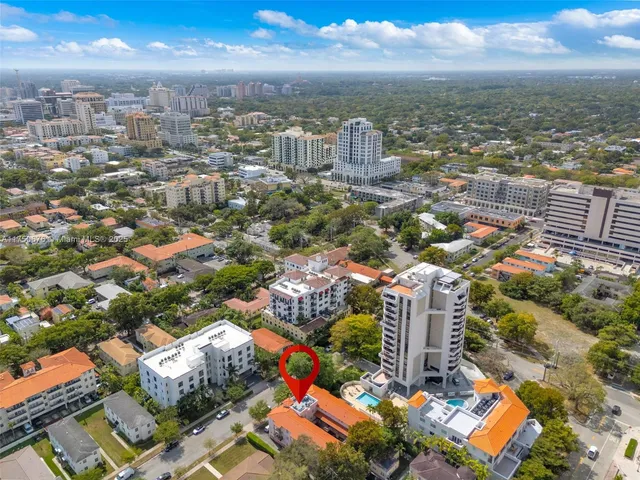 an aerial view of residential houses with city view