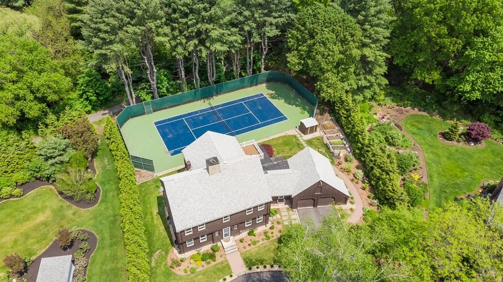 an aerial view of a house with a yard and swimming pool