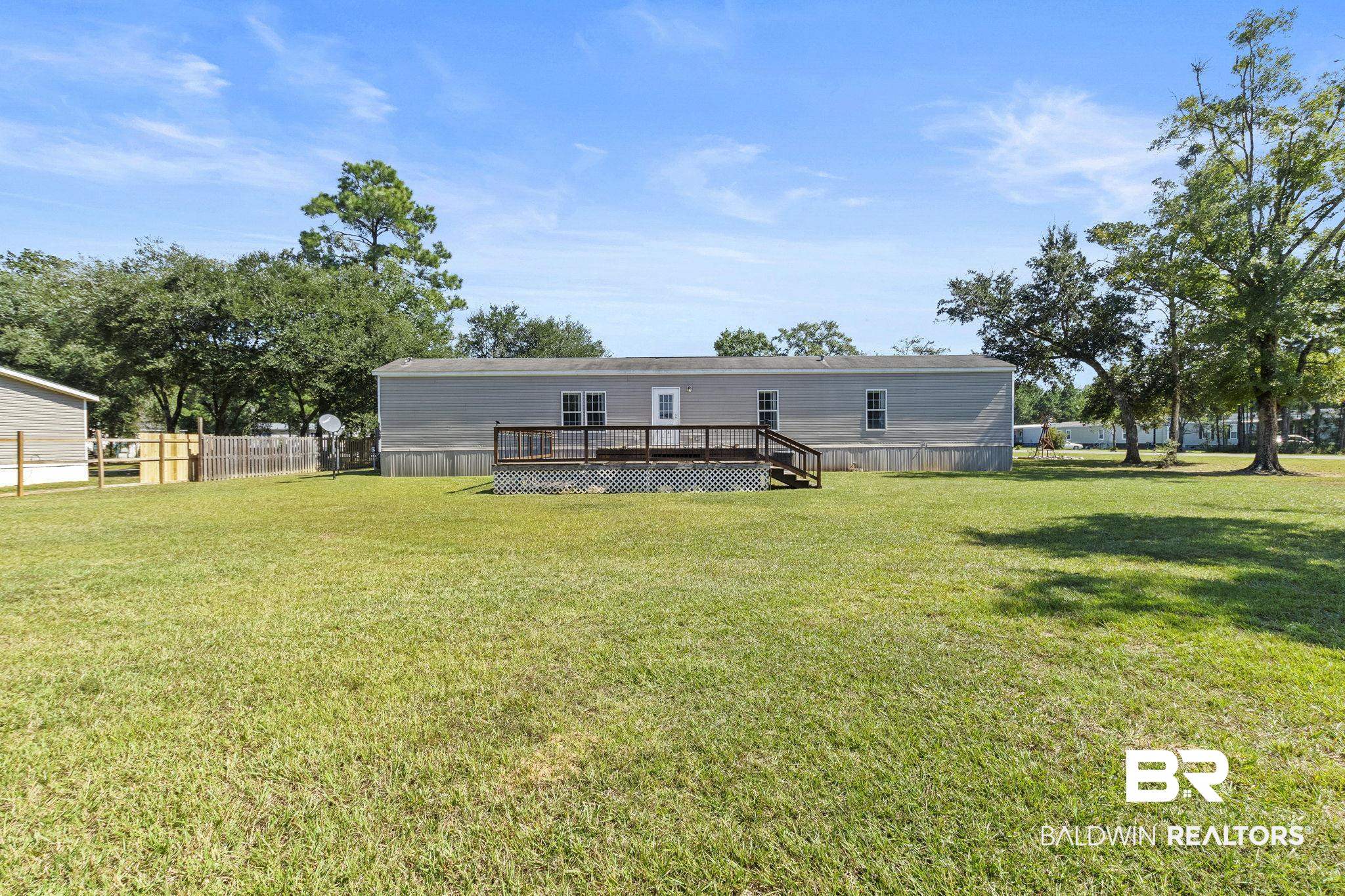 6870 Cecilia Court Theodore, AL 36582 - Photo 10 of 83 Rear view of property with a yard and a wooden deck