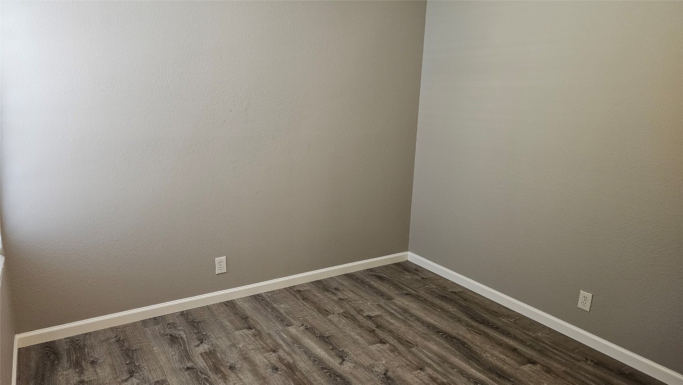 1903 1/2 Margalene Way, Unit B Austin, TX 78728 - Photo 9 of 17 Unfurnished room with dark wood-style flooring and baseboards