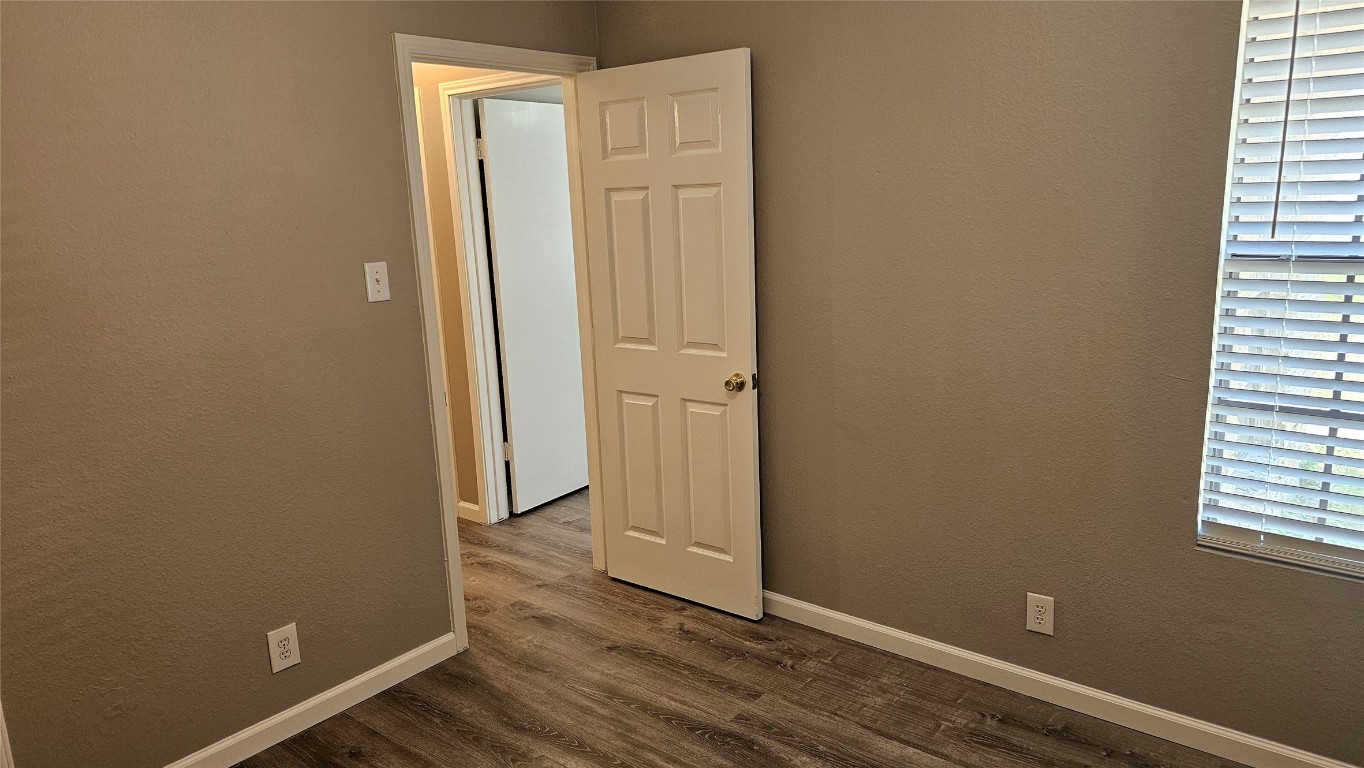 1903 1/2 Margalene Way, Unit B Austin, TX 78728 - Photo 10 of 17 Spare room featuring dark wood-style floors and baseboards