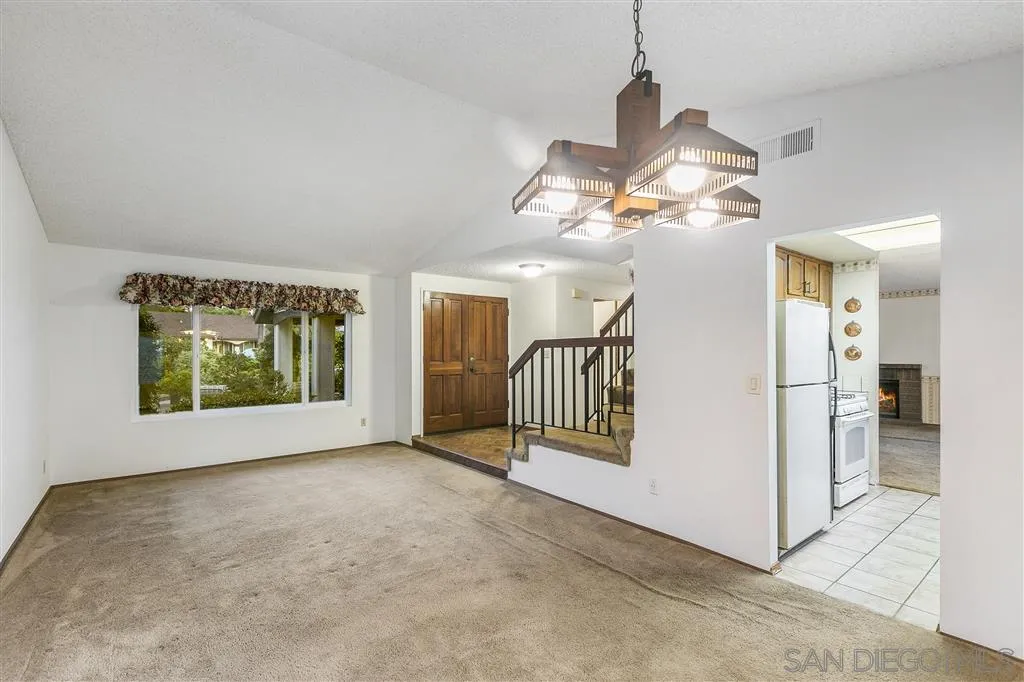 8314 Oconnell Road El Cajon, CA 92021 - Photo 6 of 25 a view of a livingroom with a staircase a ceiling fan and a window