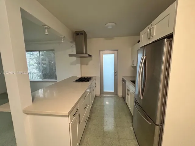 a kitchen with stainless steel appliances a refrigerator and a stove