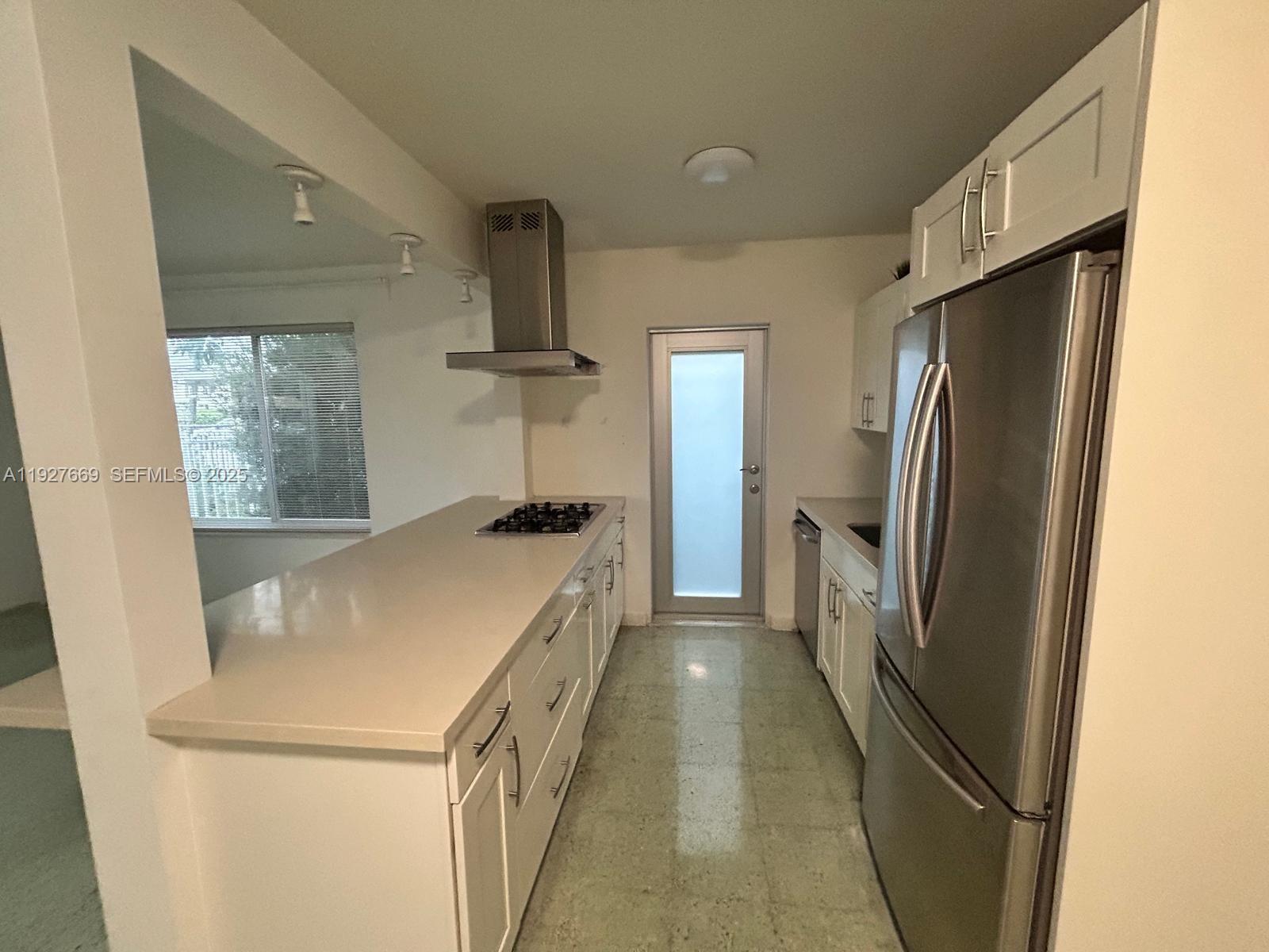 a kitchen with stainless steel appliances a refrigerator and a stove