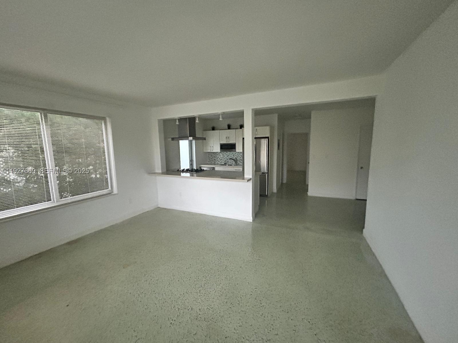 7430 Carlyle Avenue, Unit 1 Miami Beach, FL 33141 - Photo 4 of 6 an empty room with a empty space and windows