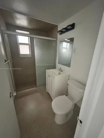 a white toilet sitting next to a bathroom sink