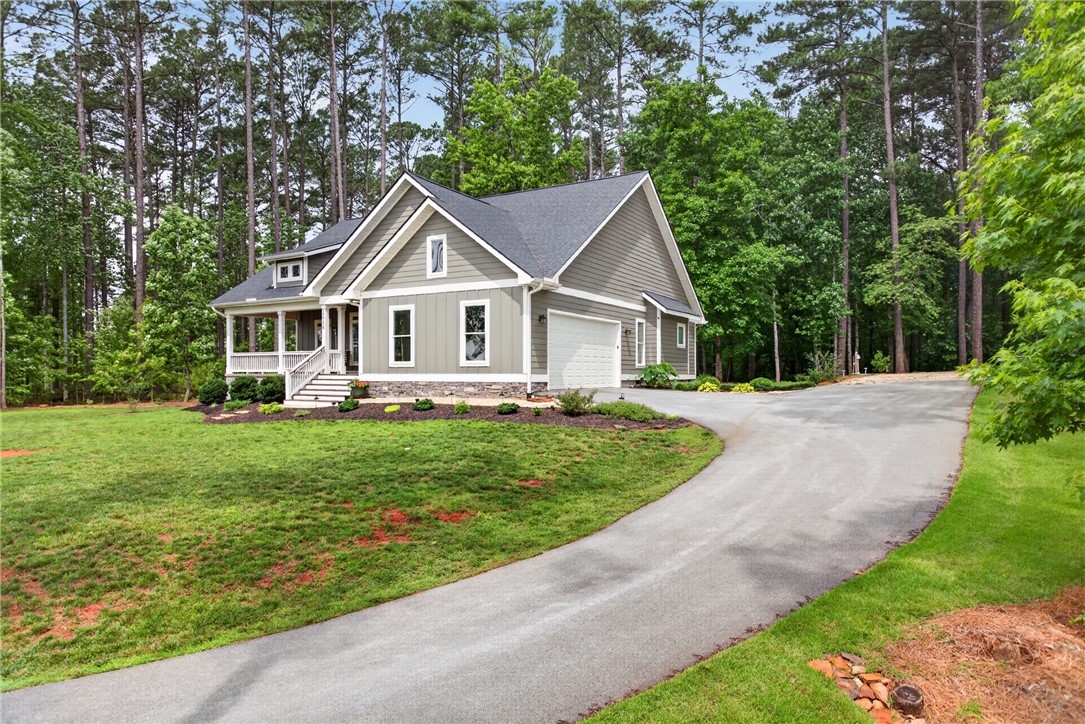 2024 Retreat Pointe Road West Union, SC 29696 - Photo 28 of 43 A graceful home nestled among mature trees, with a welcoming covered porch and an inviting driveway.