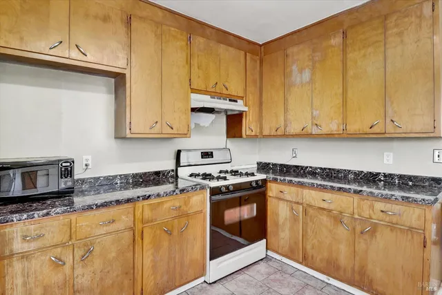 a kitchen with a stove a refrigerator and a sink