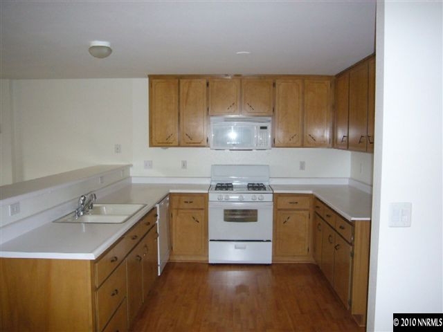568 Yellow Jacket Road Dayton, NV 89403 - Photo 4 of 13 a kitchen with a sink a stove and cabinets
