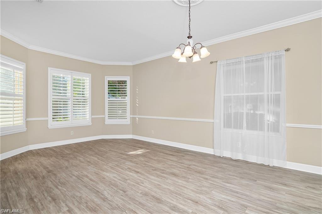 20437 Ardore Lane Estero, FL 33928 - Photo 13 of 36 a view of an empty room with a window and wooden floor