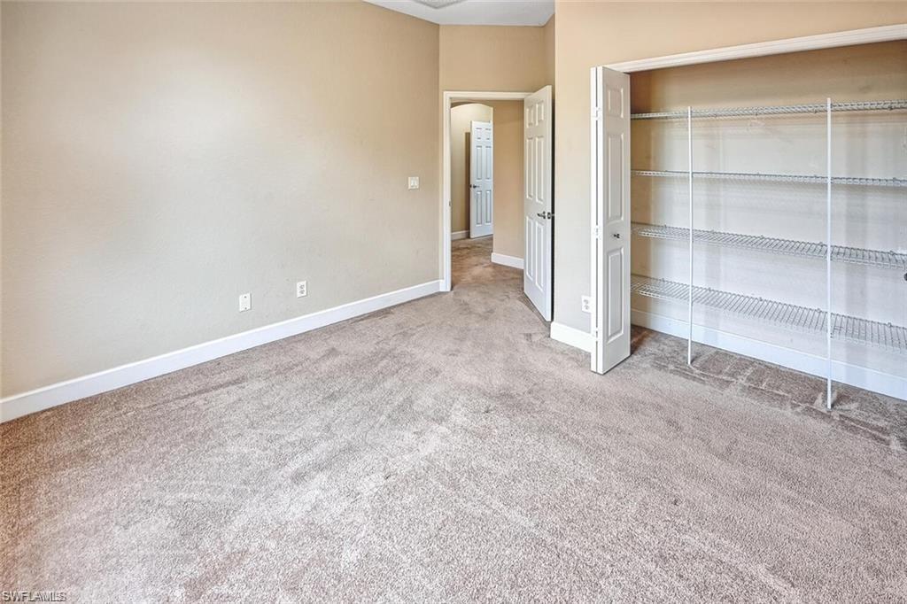 20437 Ardore Lane Estero, FL 33928 - Photo 21 of 36 a view of an empty room with a cabinet and a window