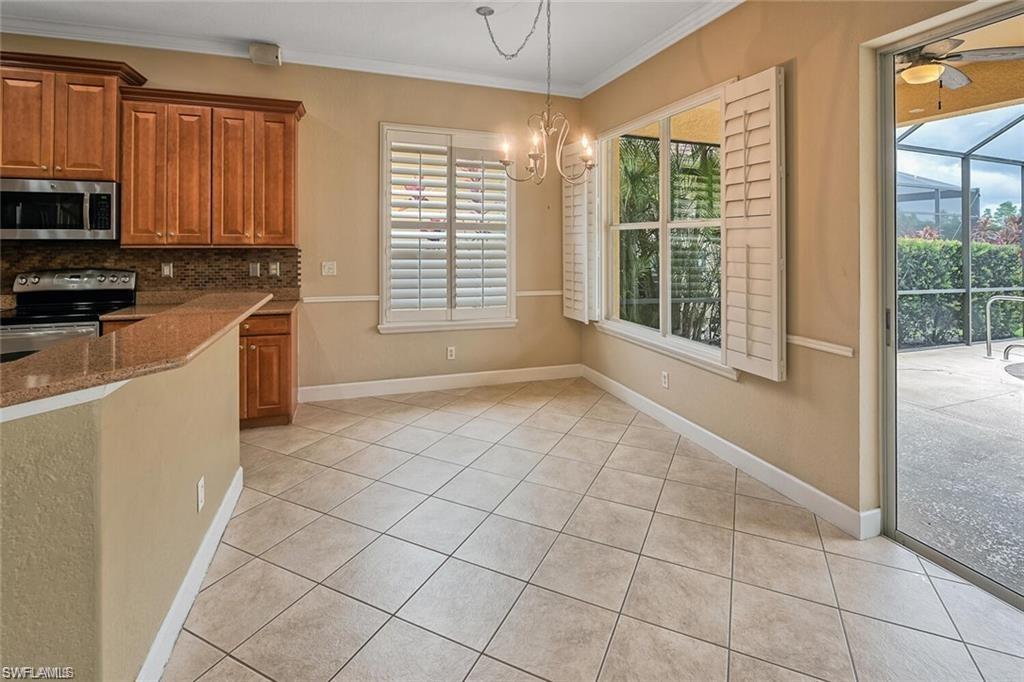 20437 Ardore Lane Estero, FL 33928 - Photo 10 of 36 a kitchen with stainless steel appliances a sink a stove a microwave and cabinets