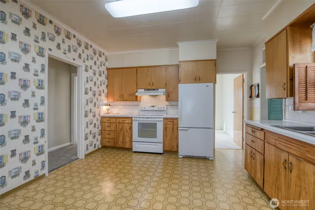 a kitchen with a refrigerator sink stove and cabinets