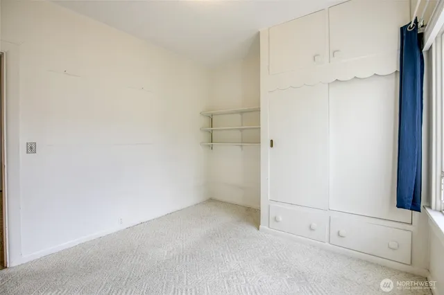 a bedroom with a bed and a chair