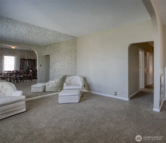 a living room with furniture and a chandelier