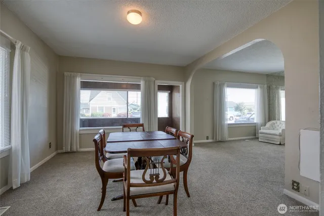 a dining room with furniture and window