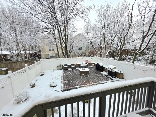 a view of a backyard with snow on the road