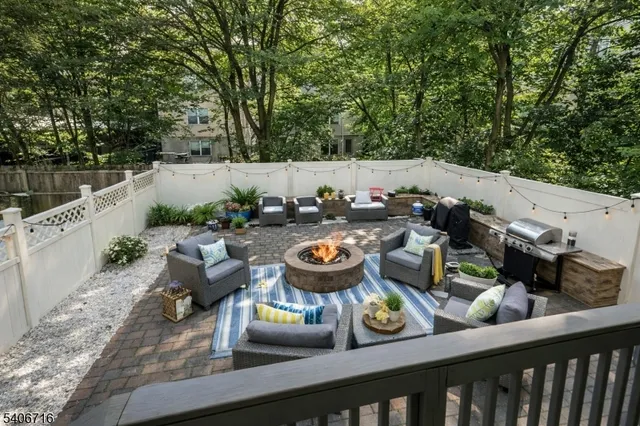 a terrace with outdoor seating and trees