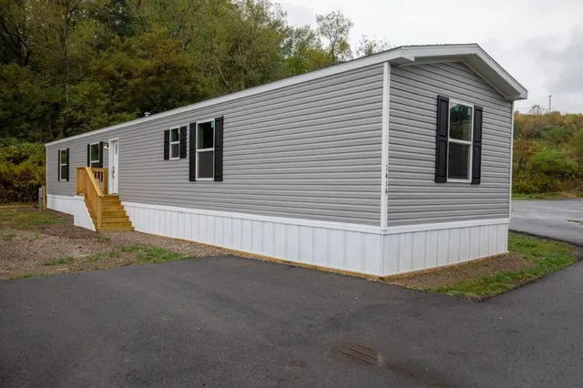 a view of a house with a backyard