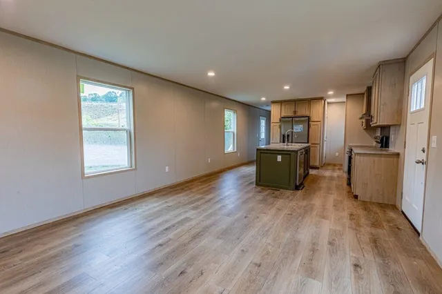 a living room with hard wood floors and furniture