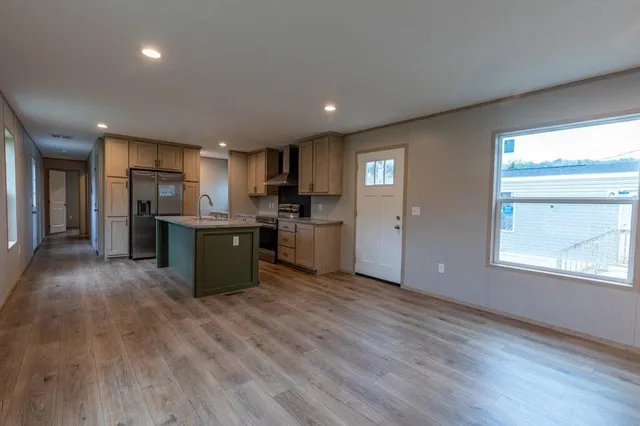 a view of kitchen with wooden floor and electronic appliances