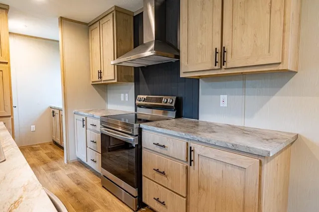 a kitchen with stainless steel appliances granite countertop a sink dishwasher stove and cabinets